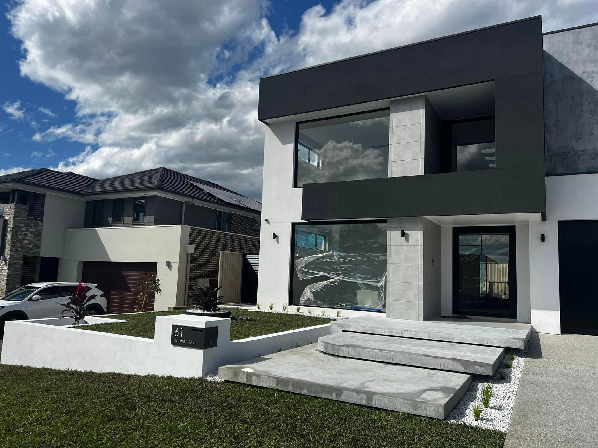 Concrete steps up to modern home