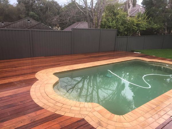 Brick paved pool surrounds with timber deck