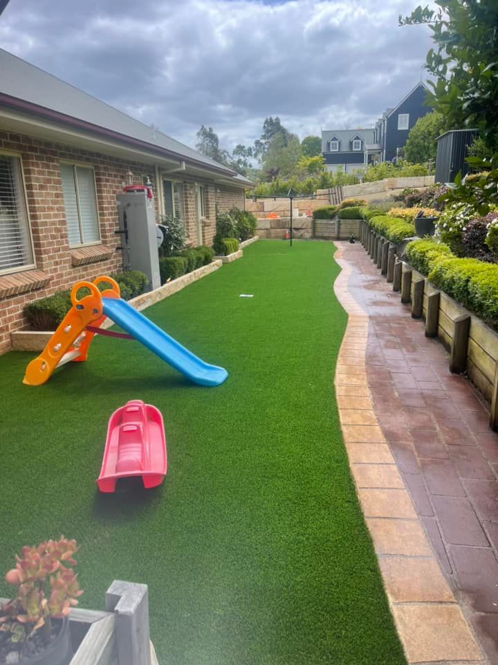 Children play area with artificial turf and pavers