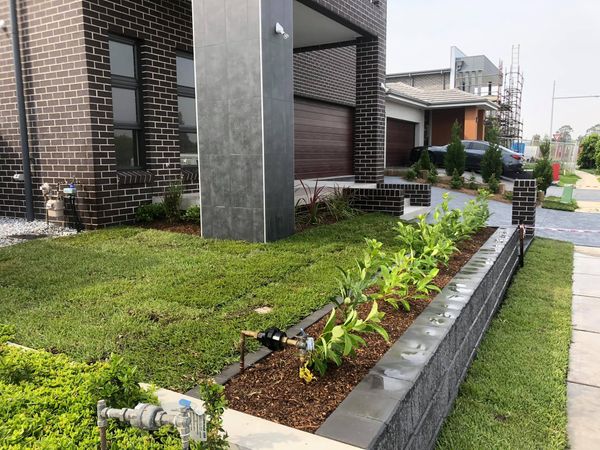 Irrigation system integrated into newly landscaped garden beds