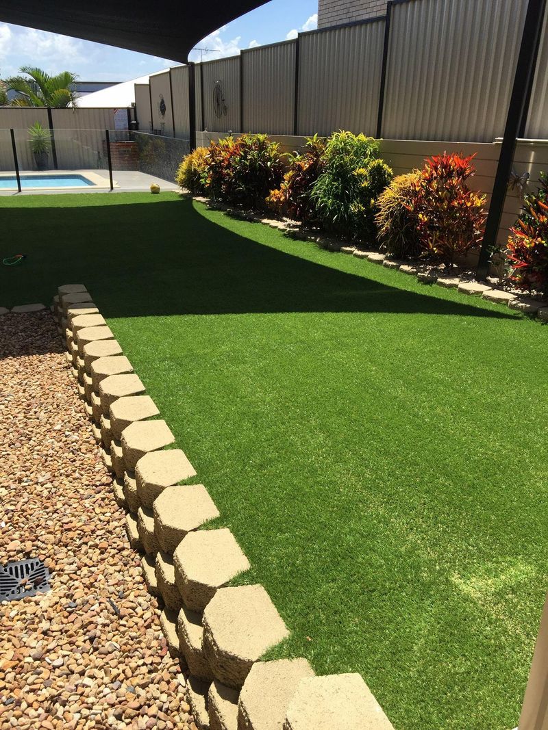 Turfing with retaining wall and shade sail